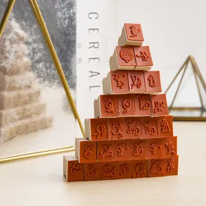 Wooden rubber stamp set featuring ornate floral script letters, neatly stacked for DIY crafts.