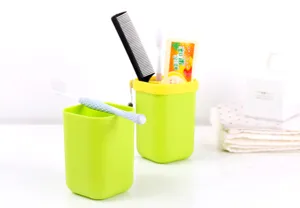 Reise tragbare Zahnbürstenbox Detailansicht grüner Kunststoffbecher mit Kamm und Zahnpasta.