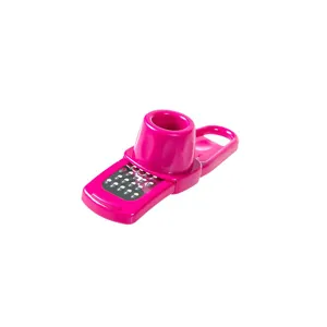 Manual garlic grater kitchen tool, pink plastic mini ginger mincer and garlic press device.