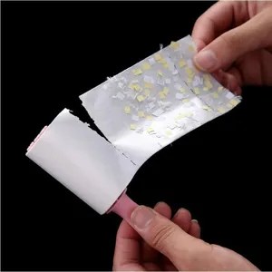 Handheld sticky lint roller with pink handle and tearable adhesive sheets for clothes.