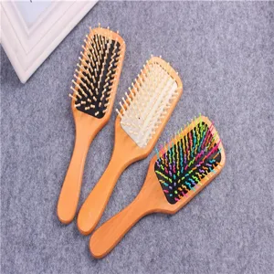 Detailed view of wooden air cushion hairbrushes with anti-static paddle design for daily hair care.