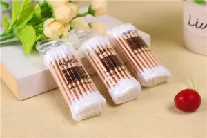 Detailed shot of disposable wooden cotton swabs in transparent bags, 80 pieces per pack format.