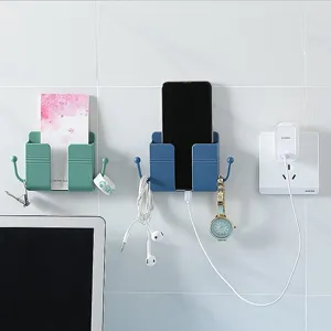 Wall-mounted phone charging holder adhesive storage box with hooks for home office use.