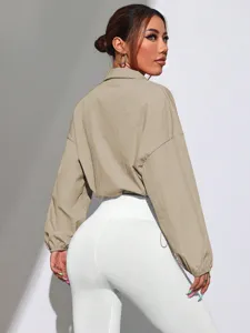 Khaki stand collar short jacket detail view showing long sleeves and matching white leggings.