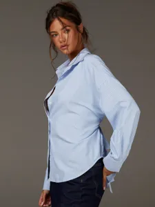 Vista dettagliata della camicia oversize a maniche lunghe a righe blu da donna con scollo V.