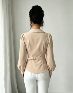 Back view detail of french lapel long sleeve blouse with waist belt and white pants.