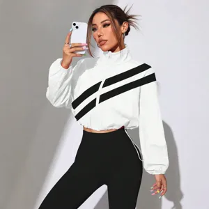 Women's white cropped track jacket with black diagonal stripes, stylish zip up stand collar top.