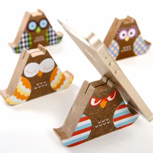 Creative cardboard owl phone stand and photo holder, vintage kraft paper design for desktop.
