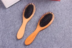 Wooden paddle hair brush detail, cushion massage bristles for smooth hair styling and care.