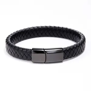 Close-up detail of stylish black braided leather bracelet featuring dark magnetic clasp.