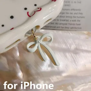 Cute phone dust plug bow charm detail view, exquisite metal pendant for iPhone charging port.