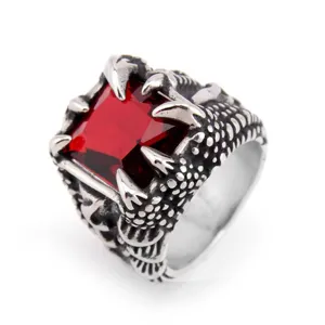 Gothic dragon claw ring with a vibrant red square gemstone, silver tone statement jewelry.