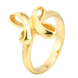 Gold titanium steel ring with unique cross ribbon design, stylish minimalist fashion jewelry.