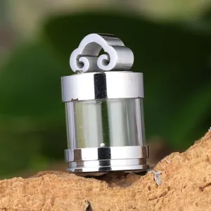 Detailed shot of titanium steel hollow glass pendant, featuring ruyi cloud top and metal frame.