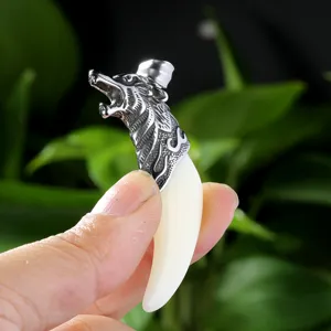 Wolf tooth pendant detail closeup, retro alloy animal head necklace accessory for men fashion.