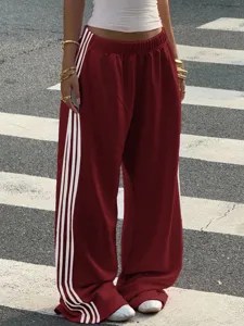 Women's autumn loose wide-leg casual sweatpants featuring iconic side stripes and comfortable fit.