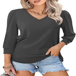 Detailed view of women's dark grey V-neck puff sleeve casual top with button cuffs.