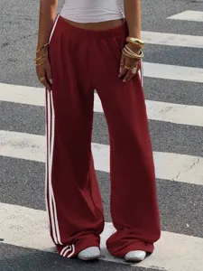 Womens loose wide leg track pants with side stripes, comfortable casual streetwear style.