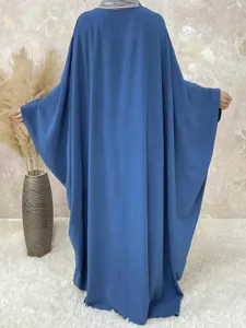 Detail view showcasing the flowy batwing sleeves and comfortable loose fit of the solid color maxi dress.