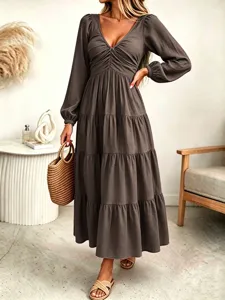Close-up detail of the elegant long-sleeve tiered maxi dress, featuring a chic V-neck design.