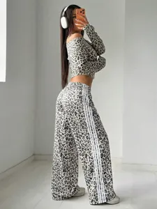 Detail view of leopard print wide-leg pants and crop top with contrast side stripes.