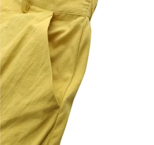 Close-up detail of yellow high-waist maxi skirt, showing pocket and waistband craftsmanship.