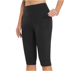 Close-up view of women's black high-waist yoga capris featuring practical side pockets.