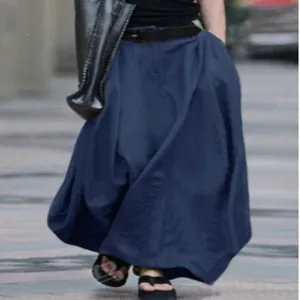 Detail view of a long navy blue A-line maxi skirt, high waist and flowing design for daily wear.