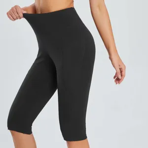Women's high-waist yoga capri leggings with side pockets, elastic athletic fitness pants detail view.