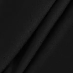 Black yoga pants stretch fabric detail close-up, premium smooth fitness leggings material.