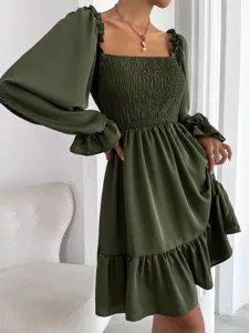 Green square neck long sleeve smocked ruffle hem mini dress detail view showcasing elastic bodice.