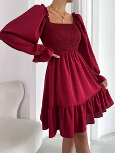 Burgundy long sleeve dress detail showcasing square neckline, smocked bodice and ruffle hem.