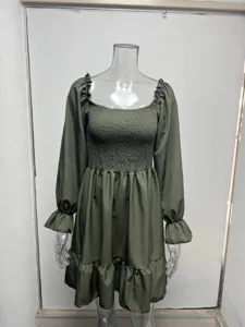 Dark green long sleeve dress with square neck, smocked bodice and ruffled hem details.