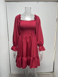 Detail view of the red long-sleeve dress featuring a square neck and ruffled hem.