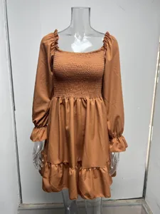 Caramel long sleeve dress with square neck, smocked bodice and ruffled hem details.