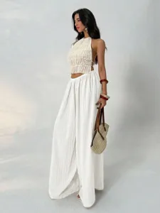 Elegant white pleated halter top and wide leg pants set, casual draped detail view.