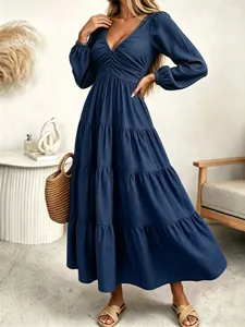 Detailed view of the elegant dark blue V-neck long-sleeve tiered maxi dress for autumn.