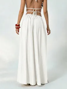 Back view detail of women's white pleated high waist wide leg pants with casual drape style.