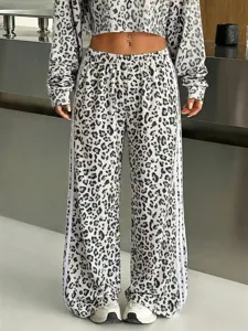 Leopard print wide leg sweatpants with contrast side stripes and matching crop top detail.