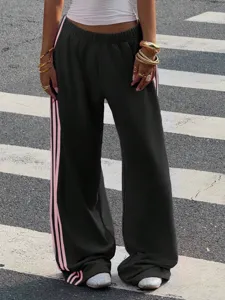 Women's American style loose sweeping knit lounge sweatpants with pink side stripes.