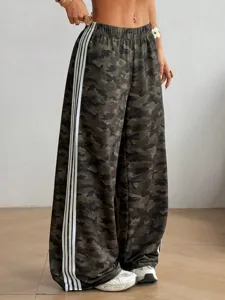 Detail shot of camouflage wide-leg pants featuring contrast triple side stripes for casual style.