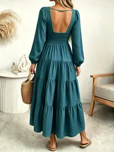Backless long sleeve green maxi dress in detailed view, elegant tiered design for women.