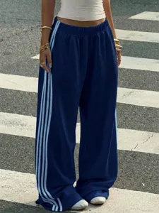 Wide leg navy blue sweatpants with light blue side stripes, comfortable streetwear casual trousers.