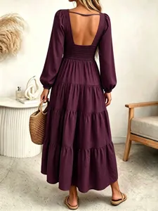 Detailed back view of the deep purple long sleeve dress showcasing the open back style.