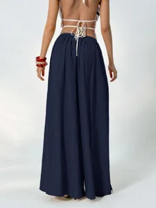 Detailed view of women's navy blue pleated wide-leg pants, high waist loose casual trousers.