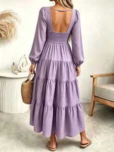 Back view of the purple long sleeve tiered maxi dress featuring open back and smocked details.