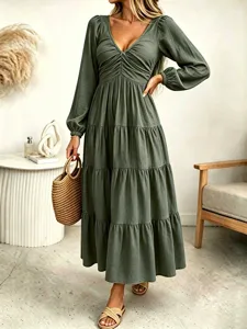 Detailed view of the olive green long sleeve maxi dress with gathered waist and tiered design.