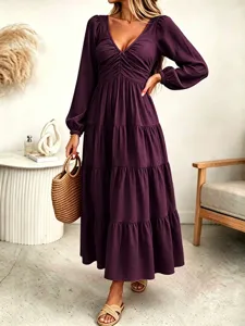 Detail view of a French style long sleeve V-line maxi dress in dark purple.