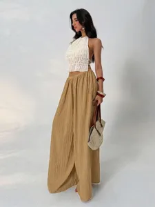 Detailed view of French style textured high-waist wide-leg pants, elegant drape and chic style.