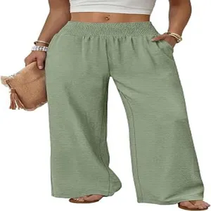 High waist wide leg green trousers detail featuring elastic waistband and side pockets.